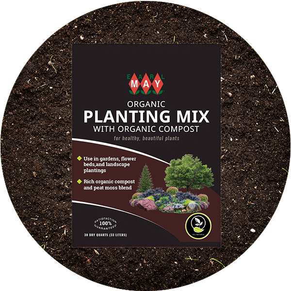 A bag of Earl May's Organic Planting Mix on top of some soil.